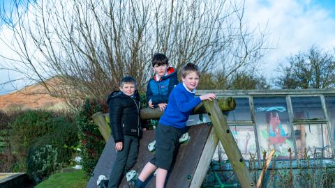 3 boys on a climbing frame