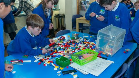 Some boys building with Lego