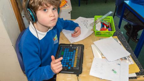 A boy making music on an iPad