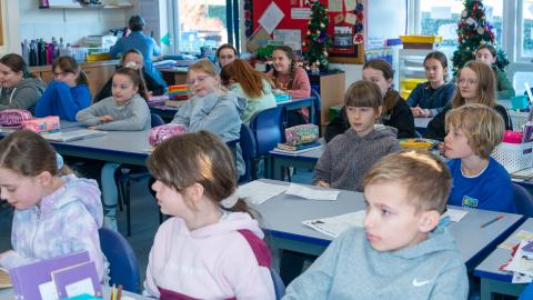 Children's sat at their desks listening to the teacher