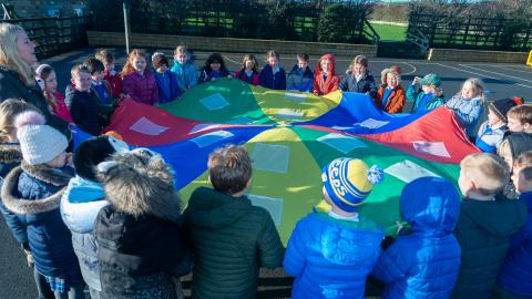 Playing with a parachute in the school playground