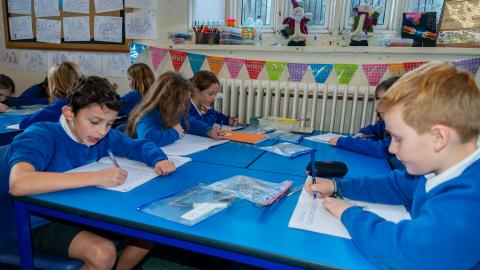 Pupils writing in their exercise books