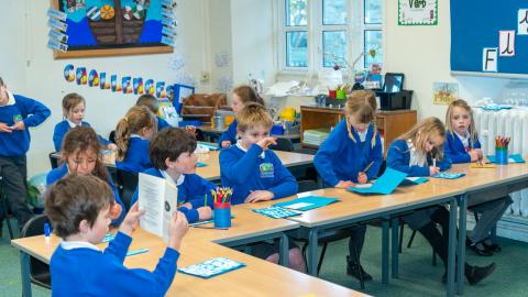 Pupils in a classroom setting completing some work