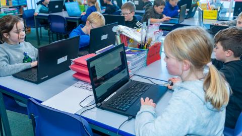 Children in an IT lesson learn about coding